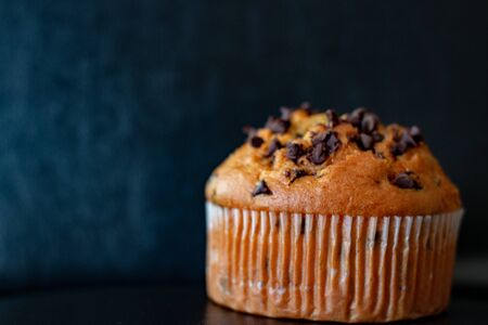 Chocolate chip muffin on a black background. Food photography, unhealthy concept.の写真素材