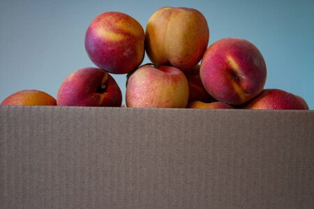 ripe peaches stacked in boxes, harvesting, peach gardenの写真素材