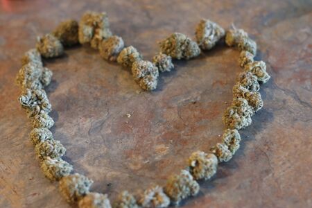 The shape of a heart made out of cannabis buds .の写真素材