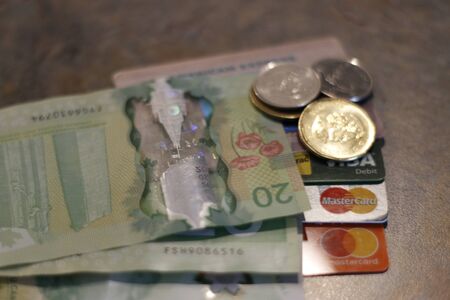 London Canada, December 25 2019: Editorial image of Canadian currency and credit cards. Theme of debt and spending.のeditorial素材
