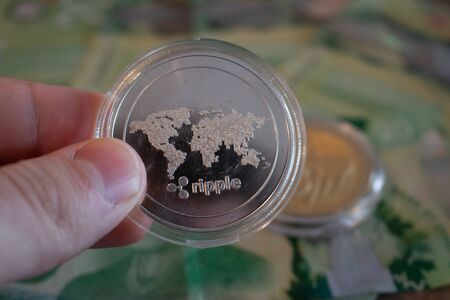 holding a ripple coin, concept of cryptocurrency and decentralized financeの写真素材