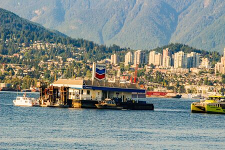 VANCOUVER, CANADA June 18 2018: Chevron Gas Station located in the Vancouver, BC harbour with Burrard Landing in the background.のeditorial素材