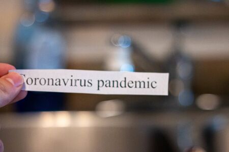 Coronavirus in front of a sink. Theme of washing hands to avoid contracting covid-19の写真素材
