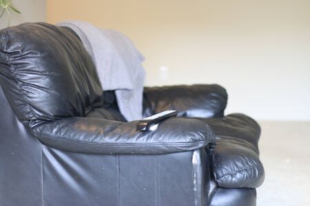 single black leather couch isolated in a living room.の写真素材
