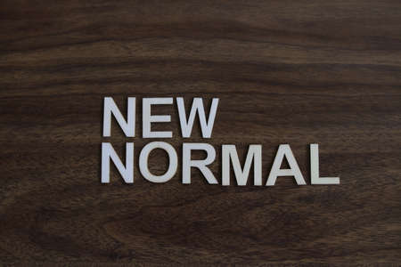 the term new normal on wood backgroundの写真素材