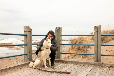 man on beach in winter, theme of active life