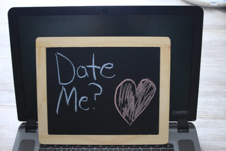 date me wrote on a black chalkboardの写真素材