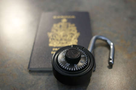 Immigration Canada application form with maple leaf. lock and passportの写真素材
