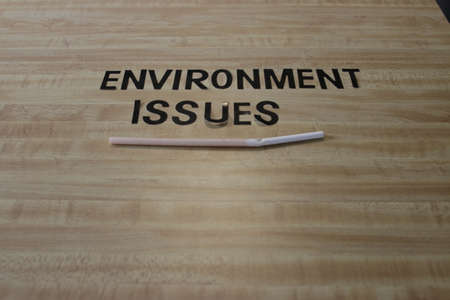 The environmental issues message Plastic Free World on paper straws. Illuminated by light from the gap.の写真素材