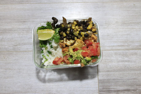 meal prep in glass lunch boxes of burrito bowls