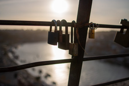 Locks on the bridge over the river at sunset, close-up
