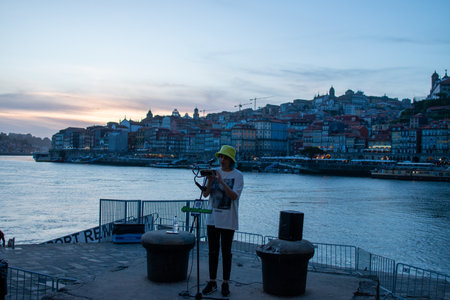 Tourist taking pictures of the Douro river at sunset.の写真素材