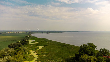 Aerial view of the lake and windmills on the horizon