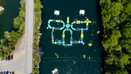 Aerial view of a park with a lot of green trees and boats