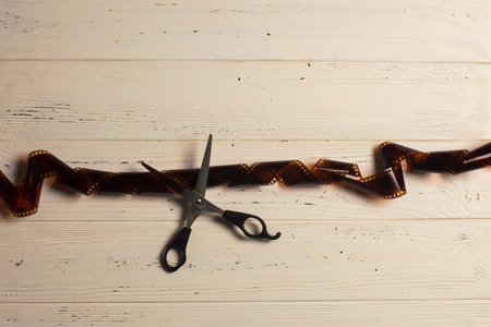 Top view of scissors cutting fiilm strip
