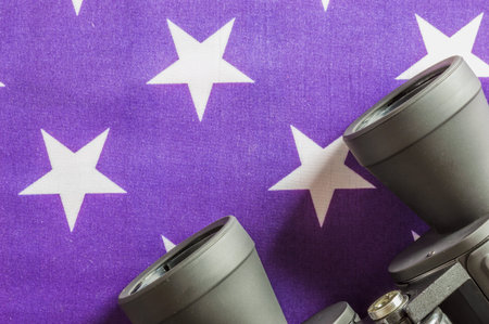 Binocular on background of US flag stars