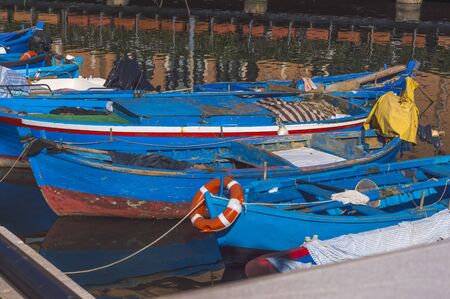Rustic boats moored in fishing harborの写真素材