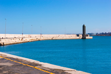 BARI, ITALY - FEBRUARY 16, 2020: lighthouse on the edge of stone pier in City of Bari, Southern...