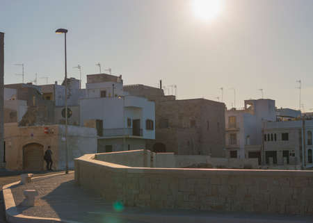 POLIGNANO A MARE, ITALY - FEBRUARY 17, 2020: calm town street scene of Polignano at sunsetのeditorial素材