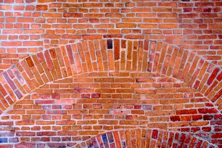 vintage natural brick wall with a lot of ancient patinaの写真素材