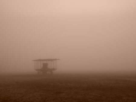 cattle trailer on a meadow in the dense morning mistの写真素材