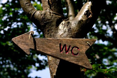 In the camping, the wooden WC sign indicates the right direction to reach the bathroomの写真素材