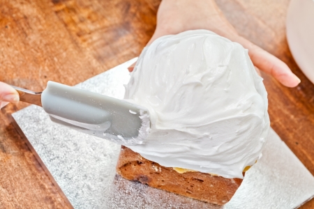 Spreading cream on christmas cake icing with spatula
の写真素材