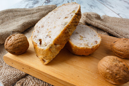 Fresh bread with walnut  on wooden board