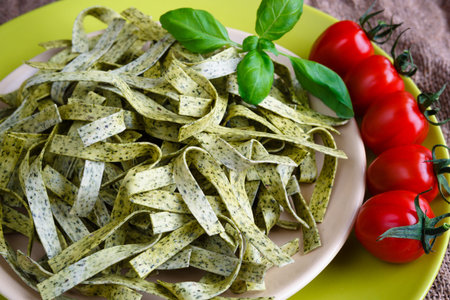 Pasta tagliatelle with spinach, basil and cherry tomatoesの写真素材