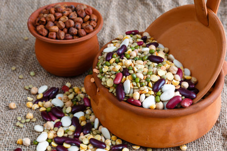 Bean colorful striped rows of lentils, beans, peas, soybeans, legumes, seed in ceramic pot on the...