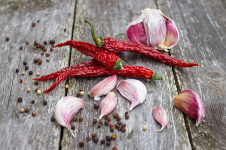 Organic garlic whole and cloves and dry chilli on the rustic wooden backgroundの写真素材