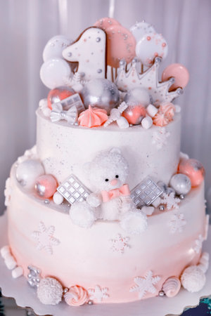three-tiered cake decorated with meringue, caramel bear, ginger one