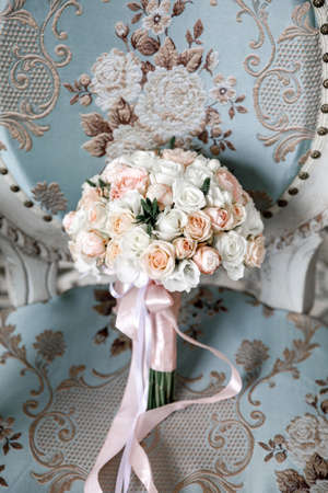 white and light pink roses on a blue vintage chair with rose embroideryの写真素材