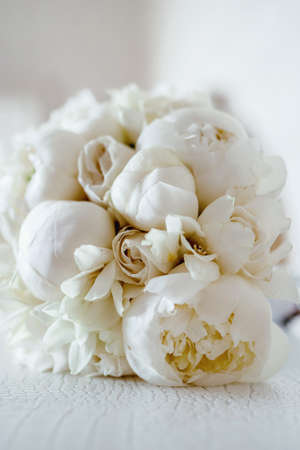 Wedding flowers, white color, bridal bouquet closeup. Decoration made of peonies close-up, selective focus, nobodyの写真素材