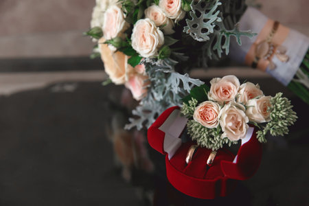 bridal bouquet of cream roses on a black glossy glass coffee table on blurred backgroundの写真素材