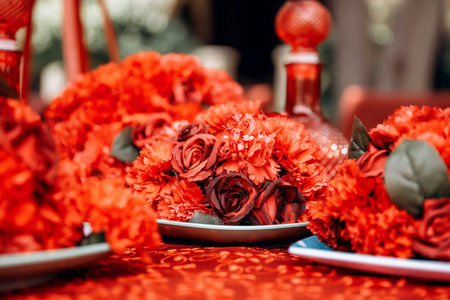 red table wedding arrangement of roses, carnations on the background of a table with a red...