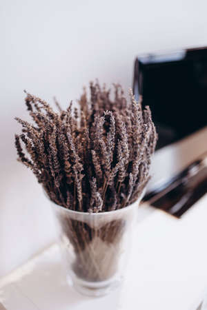 sprigs of lavender in a transparent vase on a blurred black and white backgroundの写真素材