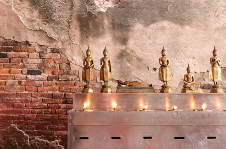 Daily Buddhas front old brick wellの写真素材