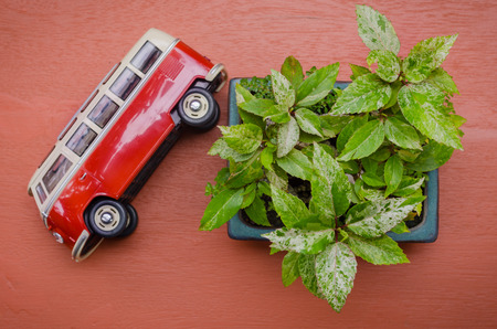 Old little red toy car and tree on 
orange wood backgroundの写真素材