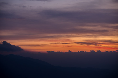 Colorful dramatic sky with cloud and mountain at sunsetの写真素材