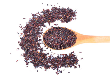 rice berry or organic rice in the spoon on white backgroundの写真素材