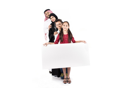 Arab family standing in raw carrying white borad on white backgroundの写真素材