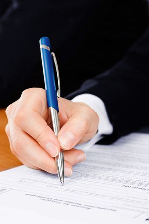 Pen in man's hand, filling the tax formの写真素材