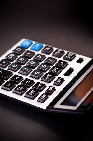 Close-up image of a calculator on a black backgroundの写真素材