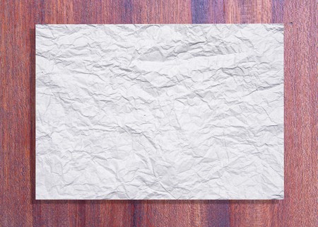 White crumpled paper on wood textureの写真素材