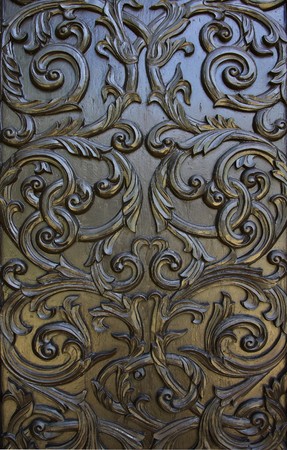 native thai style wood carving on church in thai temple の写真素材