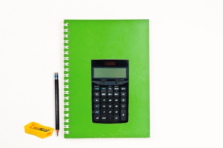 Green notebook, Calculator, Pencil and Yellow pencil-sharpener isolateの写真素材