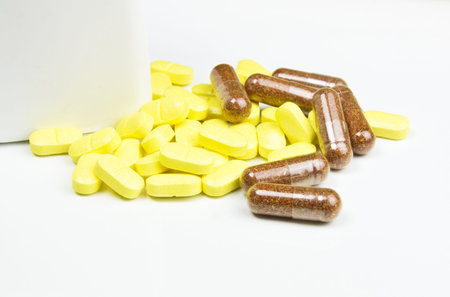 Pills and capsules on white background 