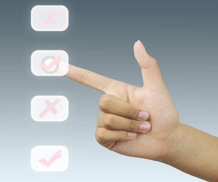 Hand puching a check mark touchscreenの写真素材