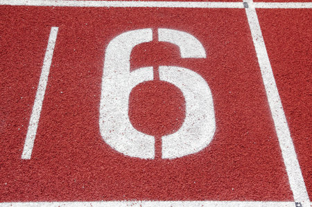 Number 6 on the start of a running track 